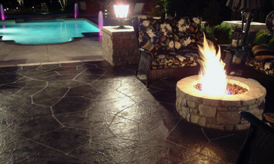 Dark brown stamped patio with built in fire pit.